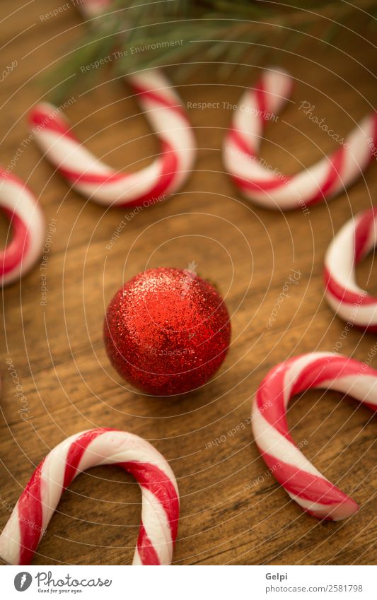 Candy canes with Christmas balls Dessert Design Joy Happy Winter Decoration Feasts & Celebrations Christmas & Advent Wood Ornament Stripe Bright Red White