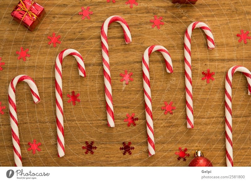 Candy canes with Christmas balls Dessert Design Joy Happy Winter Decoration Feasts & Celebrations Christmas & Advent Wood Ornament Stripe Bright Red White