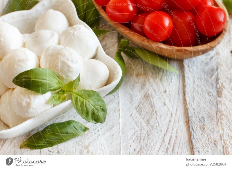 Italian cheese mozzarella with tomatoes, basil Nutrition Vegetarian diet Bowl Ball Fresh Bright Delicious Soft Green Red White Tradition Meal mediterranean