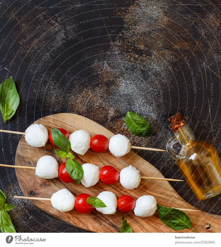 Italian cheese mozzarella with tomatoes, basil and olive oil Nutrition Vegetarian diet Bottle Ball Dark Fresh Bright Delicious Soft Green Red White Tradition
