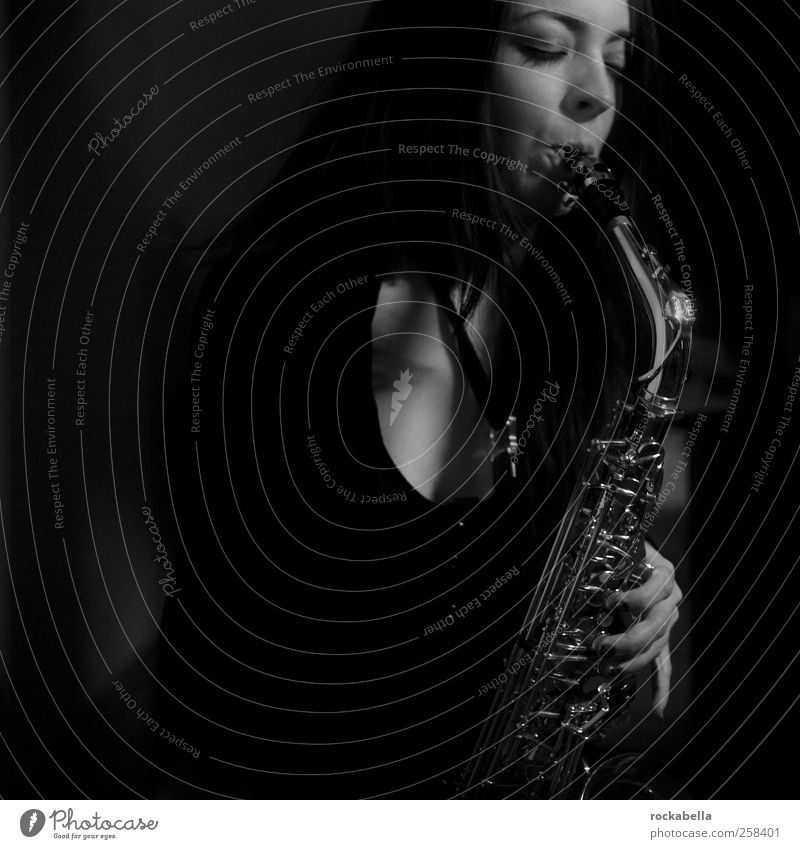solo jazz. Feminine 1 Human being Music Musician Esthetic Elegant Beautiful Uniqueness Saxophone Saxophon player Black & white photo Night Low-key