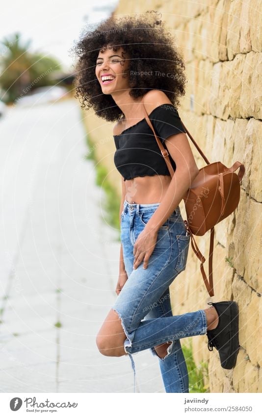 Happy mixed woman with afro hair laughing outdoors. Lifestyle Style Joy Beautiful Hair and hairstyles Face Human being Feminine Young woman Youth (Young adults)