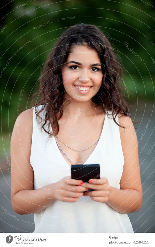 Beautiful brunette girl Lifestyle Joy Happy Summer Telephone PDA Technology Human being Woman Adults Youth (Young adults) Hand Nature Park Smiling Happiness