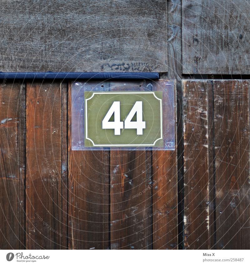 44 Wall (barrier) Wall (building) Door Digits and numbers Brown 40 House number Wooden wall Wooden board Colour photo Subdued colour Close-up Detail Pattern
