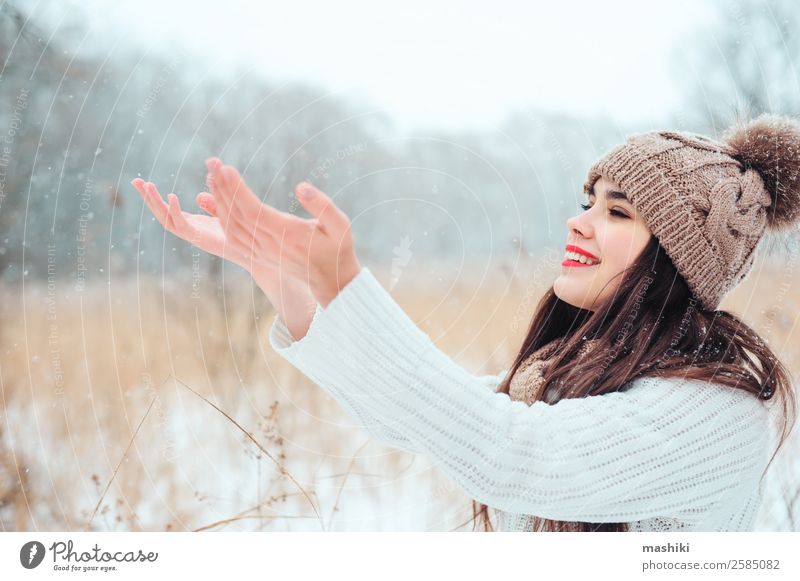 happy woman catching snowflakes on the walk Style Joy Happy Face Make-up Lipstick Knit Vacation & Travel Winter Snow Feminine Woman Adults Nature Weather