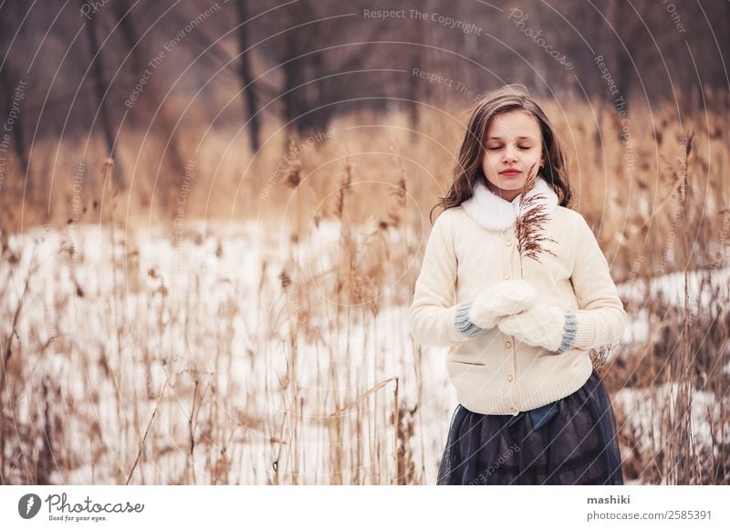 dreamy child girl walking in winter forest Joy Beautiful Leisure and hobbies Winter Snow Child Infancy Weather Tree Forest Fashion Coat Fur coat Scarf Gloves