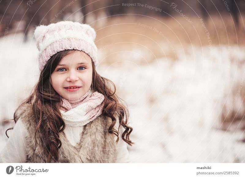 winter portrait of happy kid girl walking Joy Beautiful Leisure and hobbies Knit Winter Snow Child Infancy Weather Tree Forest Fashion Coat Fur coat Scarf