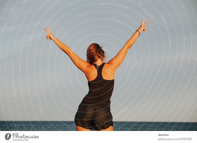 Athlete woman celebrating victory outdoors. Lifestyle Fitness Wellness Ocean Sports Sports Training Success Human being Feminine Woman Adults Arm Hand Fingers 1