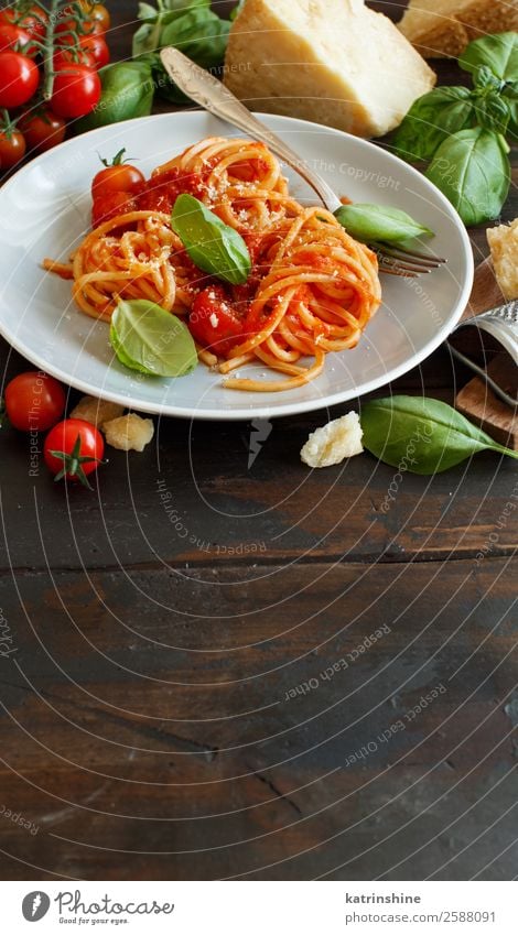 Spaghetti pasta with tomato sauce, basil and cheese Vegetable Herbs and spices Nutrition Lunch Dinner Vegetarian diet Plate Spoon Restaurant Leaf Wood Dark