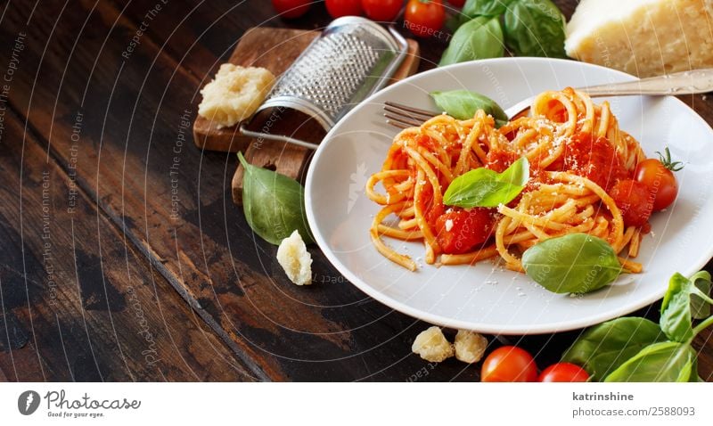 Spaghetti pasta with tomato sauce, basil and cheese Vegetable Herbs and spices Nutrition Lunch Dinner Vegetarian diet Plate Spoon Restaurant Leaf Wood Dark