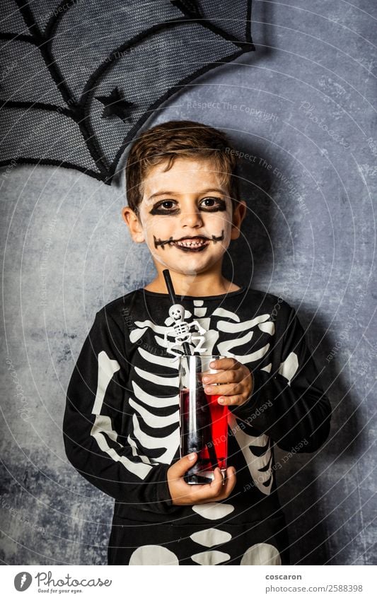 Little kid in a skeleton costume on Halloween Juice Joy Happy Beautiful Face Make-up Feasts & Celebrations Carnival Hallowe'en Fairs & Carnivals Child