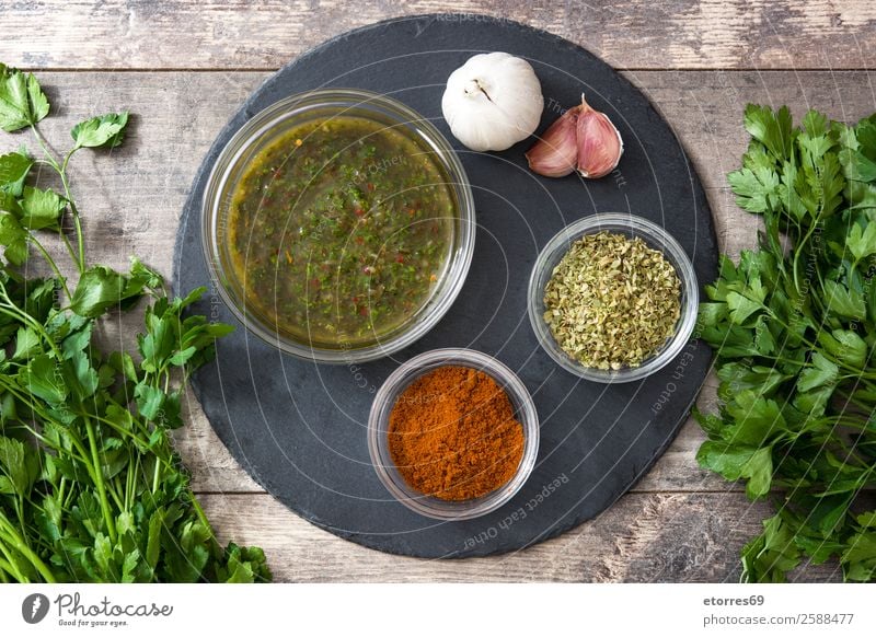 Green Chimichurri Sauce and ingredients on wooden background chimichurri Food Healthy Eating Food photograph Chili Aromatic Argentina Garlic Dish Home-made jar