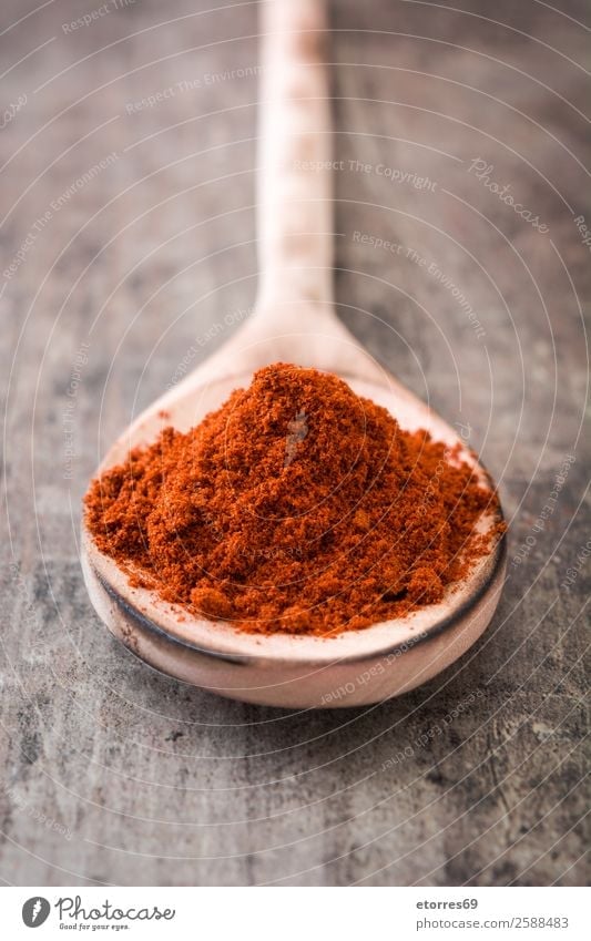 Paprika on wooden spoon on wooden background paprika Herbs and spices Food Healthy Eating Food photograph Red cayenne Chili Ingredients Pepper Powder Wood Spoon