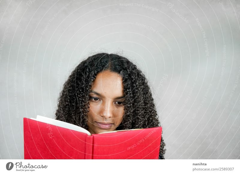 Young woman reading a book Hair and hairstyles Face Leisure and hobbies Education Adult Education Student Study Human being Feminine Youth (Young adults) Woman
