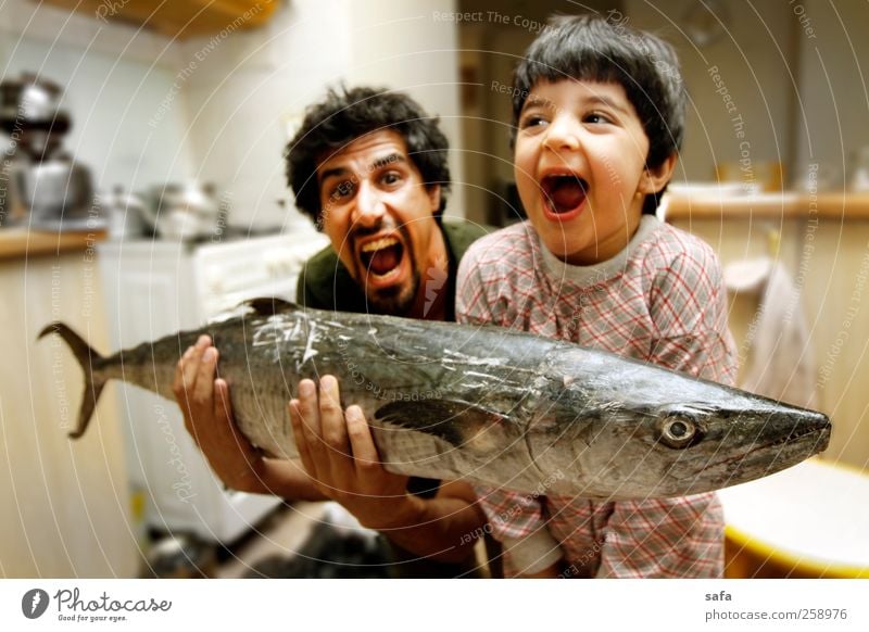 The fish Food Fish Seafood Lunch Dinner Flat (apartment) Kitchen Child Human being Masculine Girl Young man Youth (Young adults) Parents Adults Father