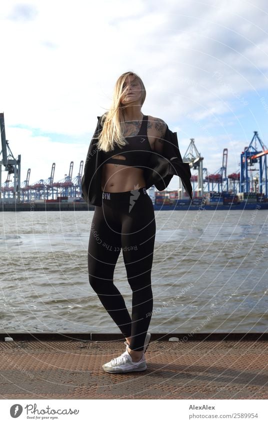 Young sportswoman at the port of Hamburg Lifestyle Joy Athletic Contentment Trip Fitness Sports Training Logistics container bridge Jetty Young woman