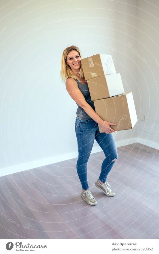 Woman carrying moving boxes Happy Beautiful House (Residential Structure) Moving (to change residence) Living room Human being Adults Book Jeans Sneakers Blonde