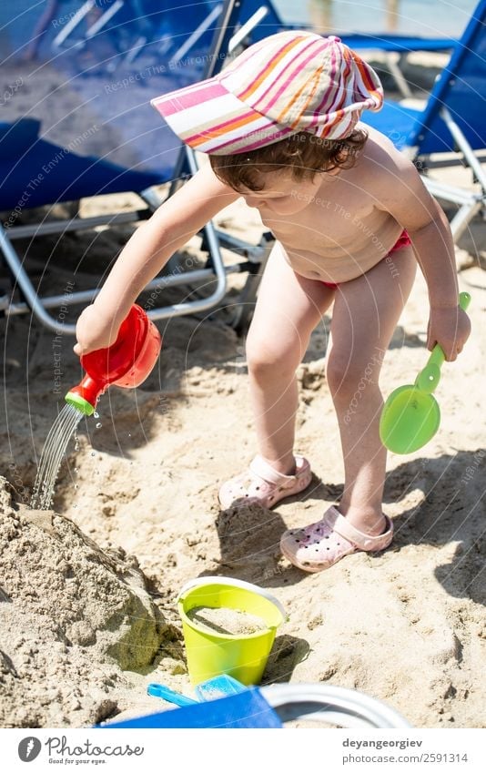 Little girl play with water on the beach Lifestyle Joy Happy Beautiful Leisure and hobbies Playing Vacation & Travel Summer Sun Beach Ocean Child
