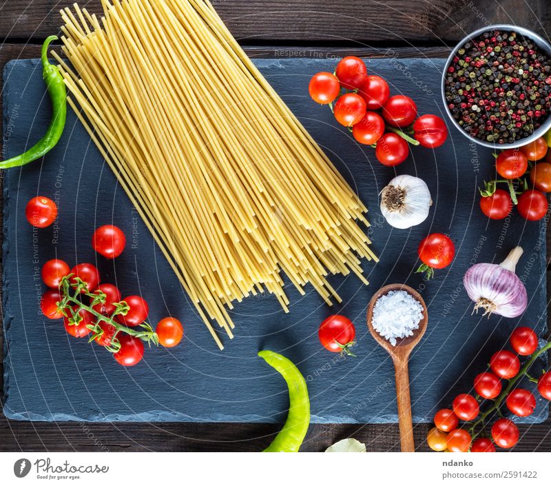 pasta spaghetti on black background Vegetable Dough Baked goods Herbs and spices Vegetarian diet Spoon Table Kitchen Wood Line Eating Fresh Large Long Above