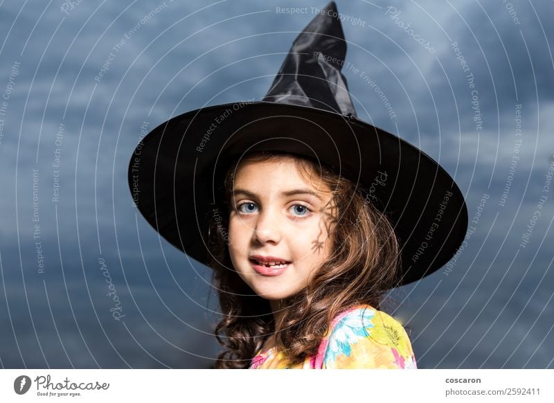 Girl disguised as a witch in Halloween Carnival Hallowe'en Child Feminine Woman Adults 3 - 8 years Infancy Sky Clouds Storm Dress Hat Brunette Cute Anger Fear