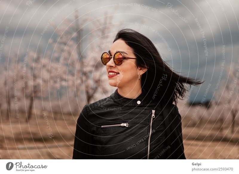 Pretty brunette girl Style Happy Beautiful Face Garden Human being Woman Adults Nature Tree Flower Blossom Park Fashion Jacket Leather Sunglasses Brunette