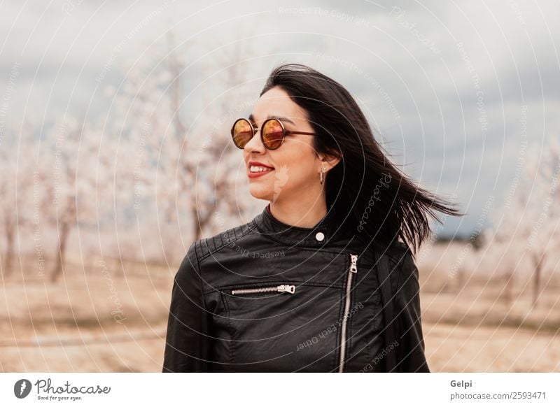 Brunette girl Style Happy Beautiful Face Garden Human being Woman Adults Nature Tree Flower Blossom Park Fashion Jacket Leather Sunglasses Smiling Happiness
