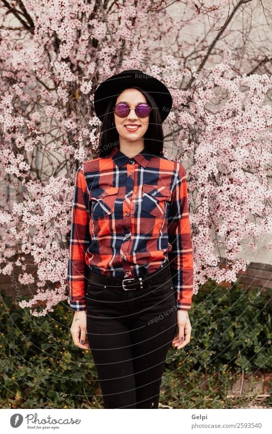 Pretty brunette girl Style Happy Beautiful Face Garden Human being Woman Adults Nature Tree Flower Blossom Park Fashion Sunglasses Hat Brunette Smiling