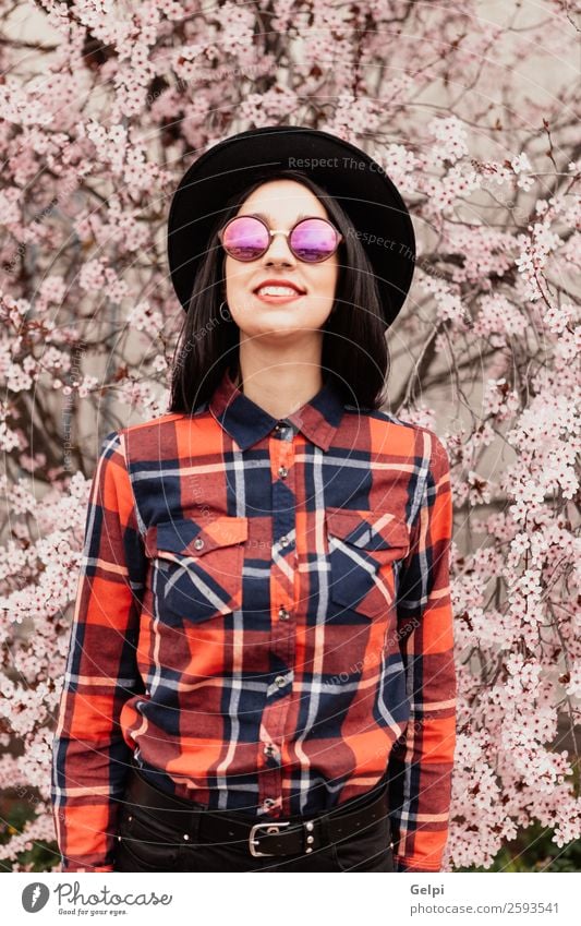 Pretty brunette girl Style Happy Beautiful Face Garden Human being Woman Adults Nature Tree Flower Blossom Park Fashion Sunglasses Hat Brunette Smiling