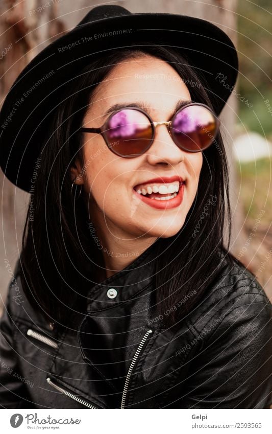 Pretty brunette girl Style Happy Beautiful Face Human being Woman Adults Lips Nature Park Fashion Jacket Leather Sunglasses Hat Brunette Think Smiling Happiness