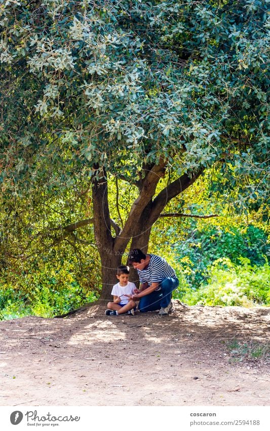 Little boy and his grandma seated under a huge tree Lifestyle Style Joy Happy Beautiful Leisure and hobbies Summer Garden Child Human being Toddler Boy (child)