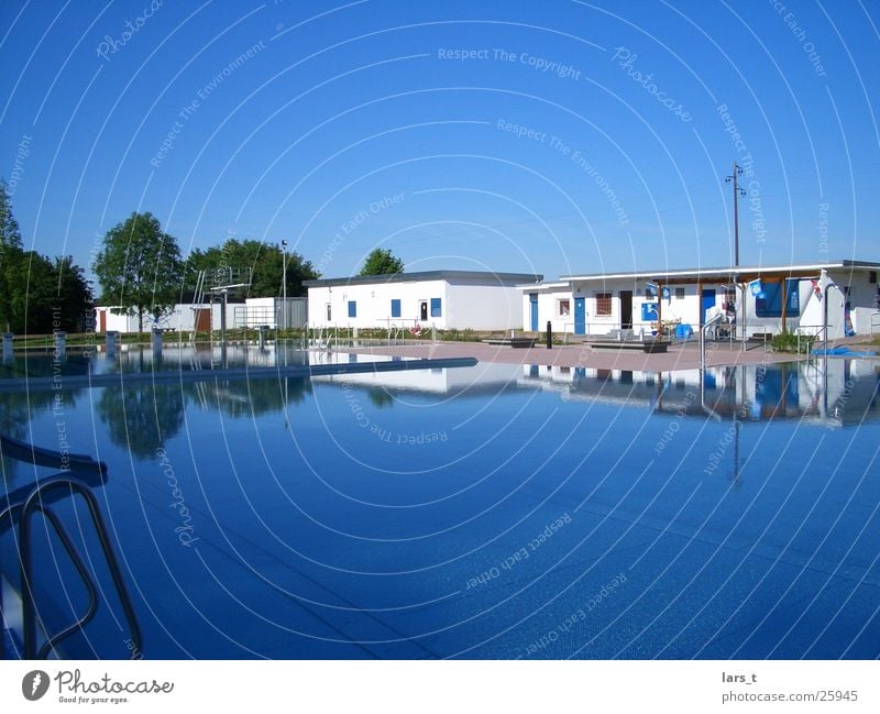 Empty outdoor pool Open-air swimming pool Wide angle Leisure and hobbies good weather Blue sky calm water no visitors