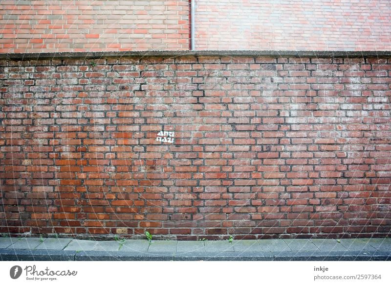Cologne Deserted Wall (barrier) Wall (building) Facade Brick Fascist Against Stone Sign Characters Moody Discordant Contempt Animosity Defiant Society