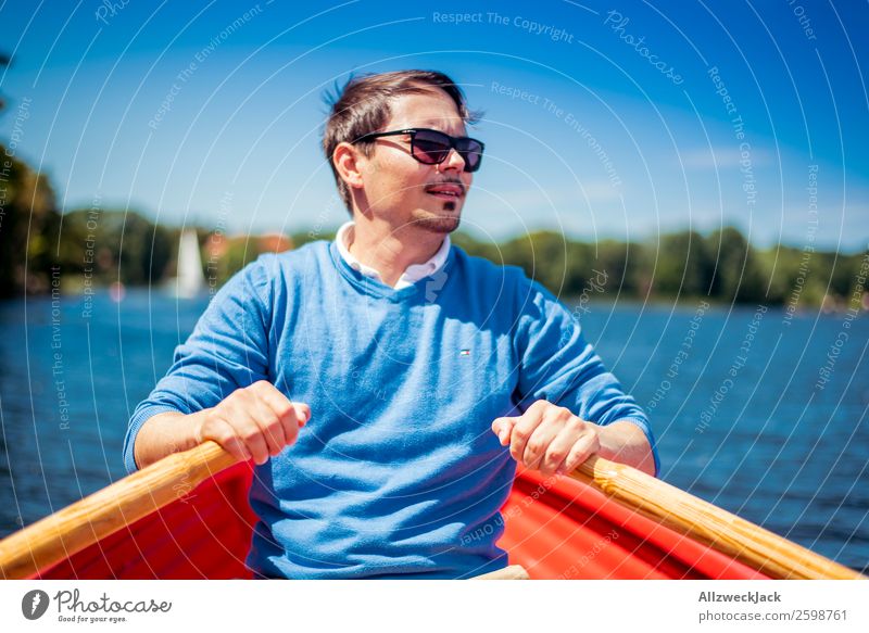 Man rowing in a boat on the lake Day Summer Blue sky Beautiful weather Leisure and hobbies Clouds Water Lake Watercraft Oar Rowing Portrait photograph Young man