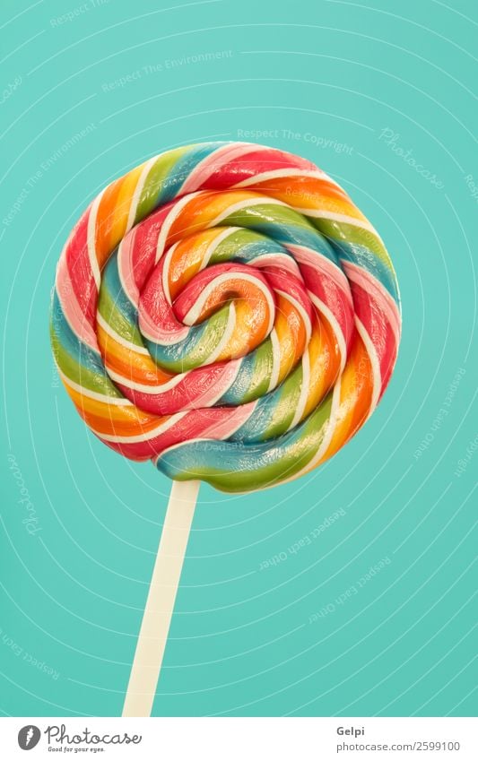 Nice lollipop with many colors in a spiral on a blue background Dessert Eating Joy Infancy Bright Delicious Retro Blue Red White Colour candy food Lollipop
