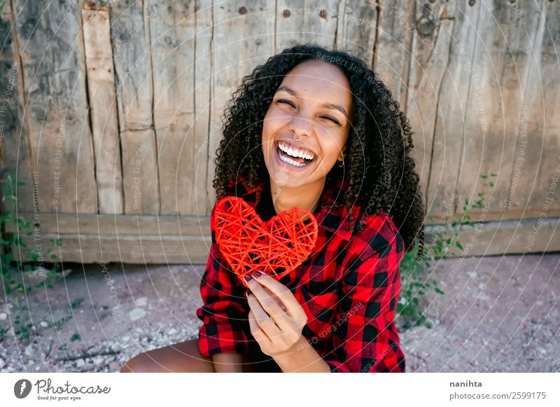 Beautiful young woman holding a red heart Lifestyle Style Joy Hair and hairstyles Human being Feminine Young woman Youth (Young adults) Woman Adults 1