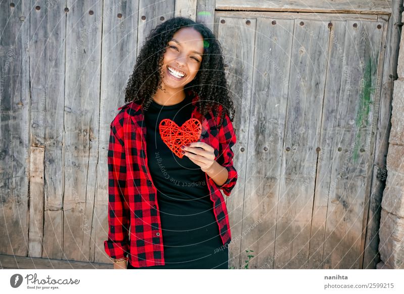 Beautiful young woman holding a red heart Lifestyle Style Joy Hair and hairstyles Human being Young woman Youth (Young adults) Woman Adults 1 18 - 30 years