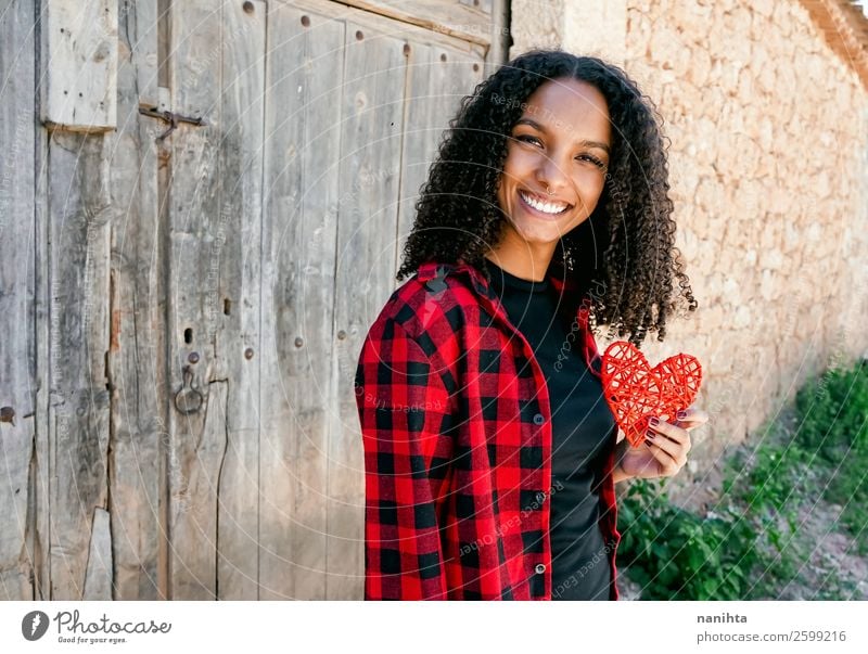 Beautiful young woman holding a red heart Lifestyle Style Joy Hair and hairstyles Healthy Wellness Human being Young woman Youth (Young adults) Woman Adults 1