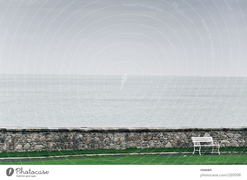 bench Landscape Bad weather Waves Coast Lakeside Ocean Dark Cold Bench Sit Seat Wall (barrier) Stone Water Grass surface Fog Park Relaxation Calm Resting point