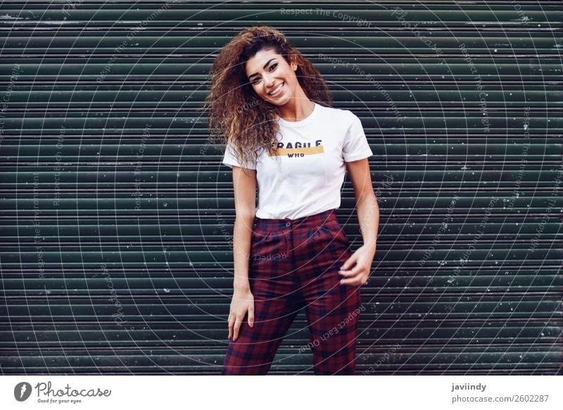 Smiling young arabic woman with black curly hairstyle Lifestyle Style Joy Happy Beautiful Hair and hairstyles Face Human being Feminine Young woman