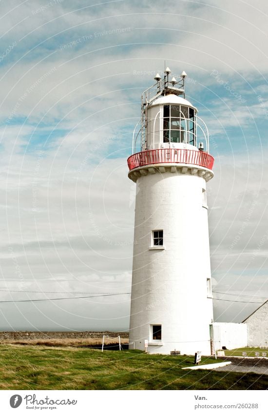 lighthouse Environment Air Sky Clouds Grass Coast Ireland Tower Lighthouse Window Stone Large Tall Loneliness Calm High voltage power line Handrail Red Signal
