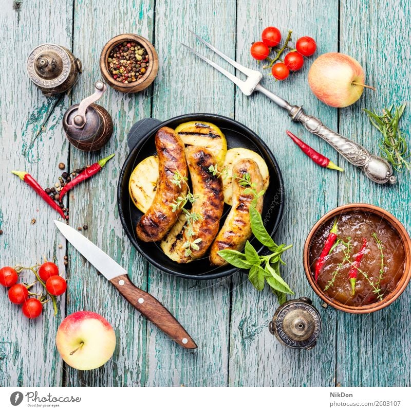Grilled sausages in frying pan grilled meat barbecue food pork bbq meal dinner chilli roasted apple fruit beef sauce table spicy dish fried herb kitchen pepper
