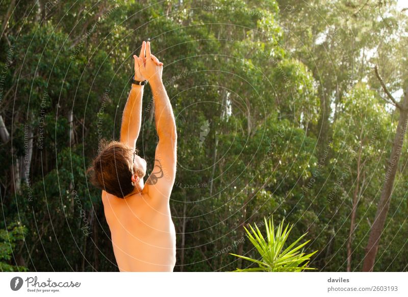 Man doing yoga in nature. Lifestyle Wellness Harmonious Relaxation Calm Meditation Summer Yoga Human being Masculine Adults Back Arm 1 30 - 45 years Nature