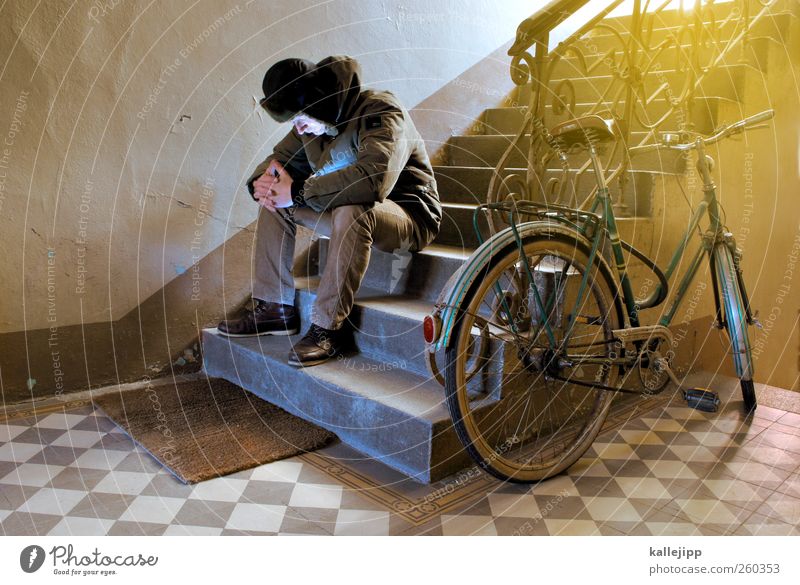 too cold to ride a bike Human being Body 1 Sit Bicycle Stairs Staircase (Hallway) Grief Jacket Cap Parking area Handrail Old building Colour photo Interior shot