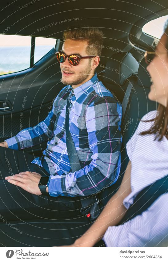 Young couple traveling by car with seat belts on Lifestyle Beautiful Leisure and hobbies Vacation & Travel Trip Human being Woman Adults Man Friendship Couple