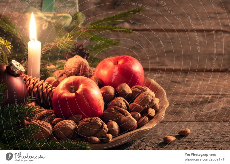 Platter with nuts and apples in Xmas decor Apple Happy Winter Decoration Table Candle Retro Tradition Christmas settings Atmosphere candlelight colorful context