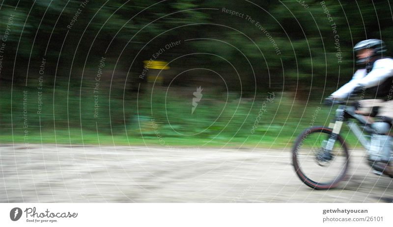 sound barrier Bicycle Speed Forest Helmet Man Blur Gravel Extreme sports Lanes & trails Nature Brave Movement Front side Exterior shot