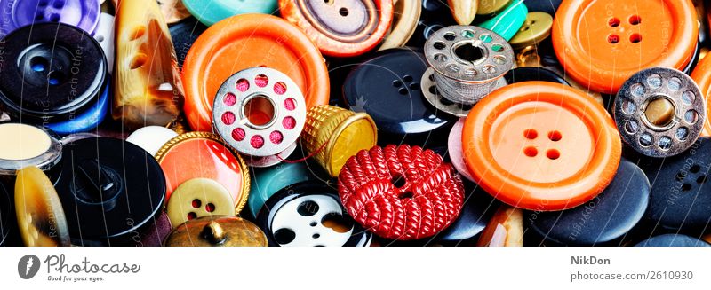 Set sewing buttons fashion clothing tailor design circle background thread bobbin collection plastic colorful needlework closeup group many retro various macro