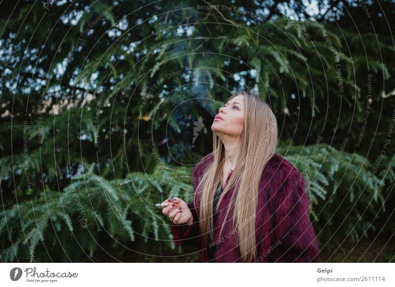 Pretty blond girl with long hair smoking - a Royalty Free Stock Photo from  Photocase
