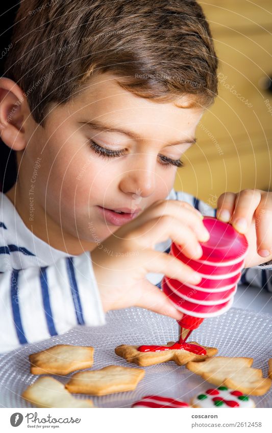 Little kid decorating Christmas biscuits at Christmas day Food Dough Baked goods Cake Dessert Lifestyle Joy Happy Leisure and hobbies Children's game Decoration