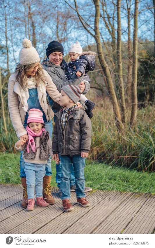 Happy family enjoying together leisure in the forest Lifestyle Joy Leisure and hobbies Winter Child Boy (child) Woman Adults Man Parents Mother Father Sister
